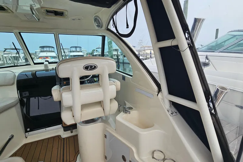  Yacht Photos Pics 2009 Pursuit OS 315 Offshore boat interior with helm and seating area.