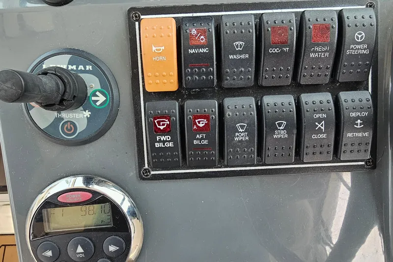  Yacht Photos Pics Control panel of a 2009 Pursuit OS 315 Offshore boat with various switches and gauges.
