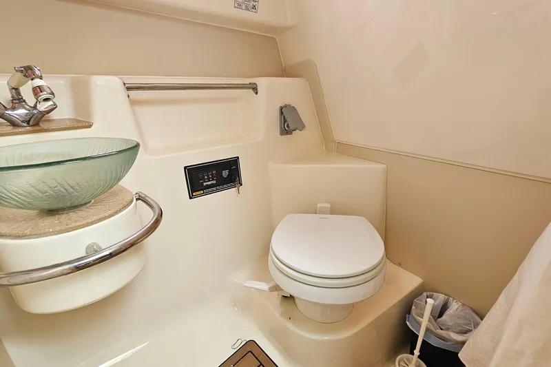  Yacht Photos Pics 2009 Pursuit OS 315 Offshore boat bathroom with glass sink and toilet.