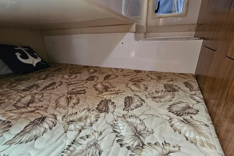  Yacht Photos Pics 2009 Pursuit OS 315 Offshore cabin with leaf-patterned bedding and anchor pillow.