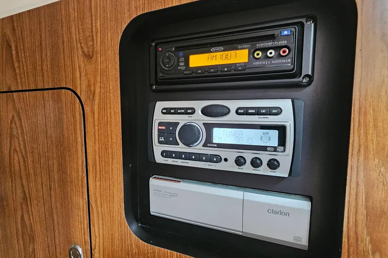  Yacht Photos Pics 2009 Pursuit OS 315 Offshore cabin audio system with Clarion controls and wood paneling.