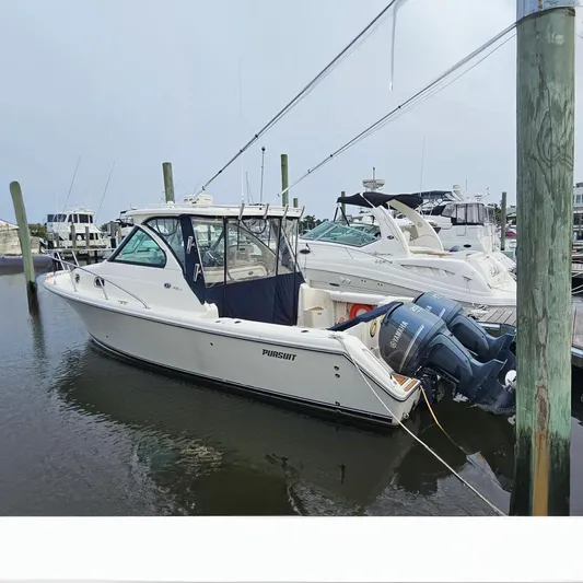  Yacht Photos Pics 2009 Pursuit OS 315 Offshore boat docked in marina, featuring twin outboard engines.