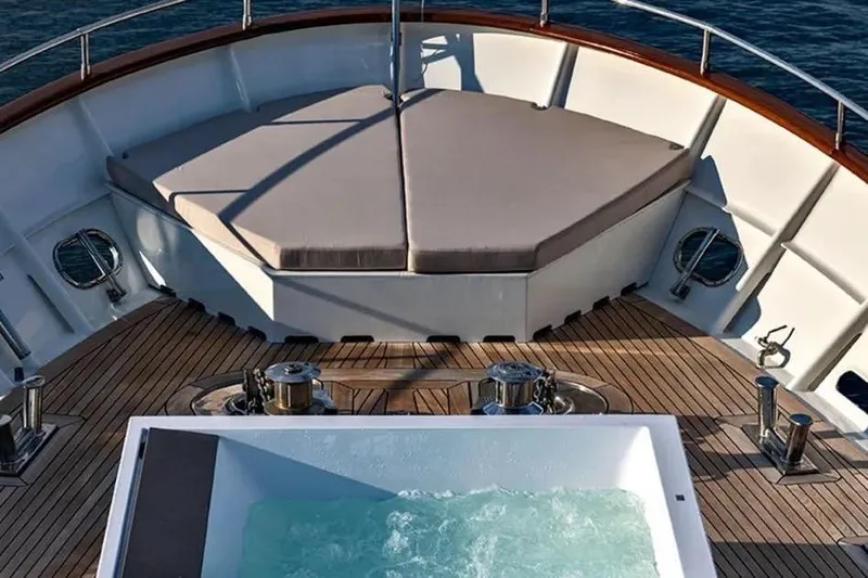  Yacht Photos Pics Luxurious deck of 2002 Benetti Sail Division 105 yacht with jacuzzi and seating area.