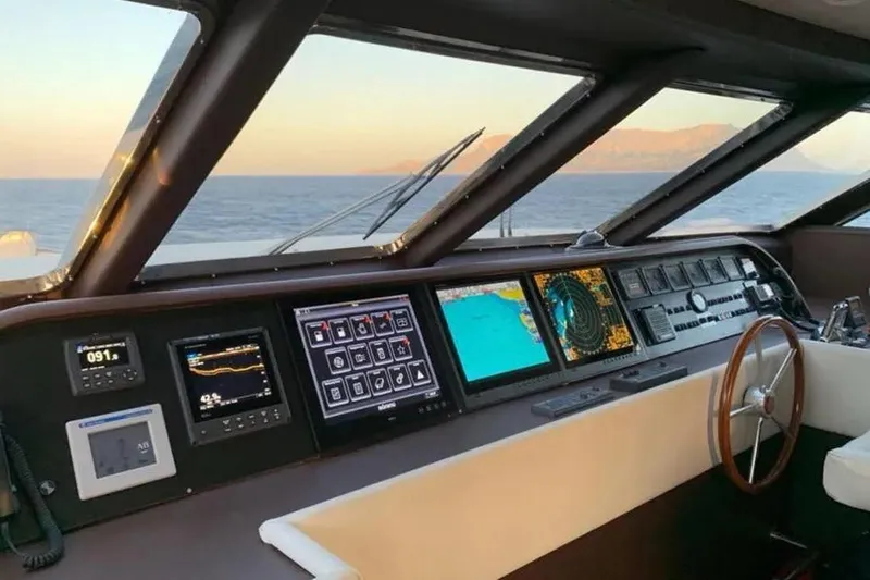  Yacht Photos Pics Bridge of 2002 Benetti Sail Division 105 yacht with navigation screens and steering wheel.