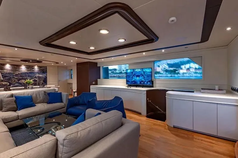  Yacht Photos Pics Luxurious interior of 2002 Benetti Sail Division 105 yacht with modern decor and comfortable seating.