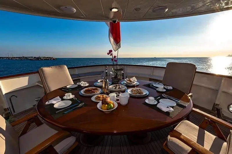  Yacht Photos Pics Luxury dining setup on 2002 Benetti Sail Division 105 yacht, overlooking serene ocean view.