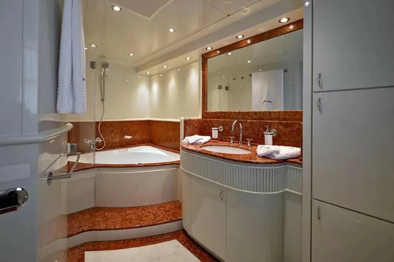  Yacht Photos Pics Luxurious bathroom on 2002 Benetti Sail Division 105 yacht with elegant fixtures and marble accents.
