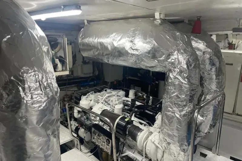  Yacht Photos Pics Engine room of 2002 Benetti Sail Division 105 yacht, featuring insulated exhaust systems.