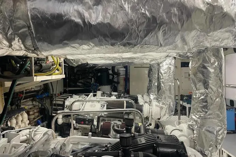  Yacht Photos Pics Engine room of 2002 Benetti Sail Division 105 yacht, featuring complex machinery and insulation.