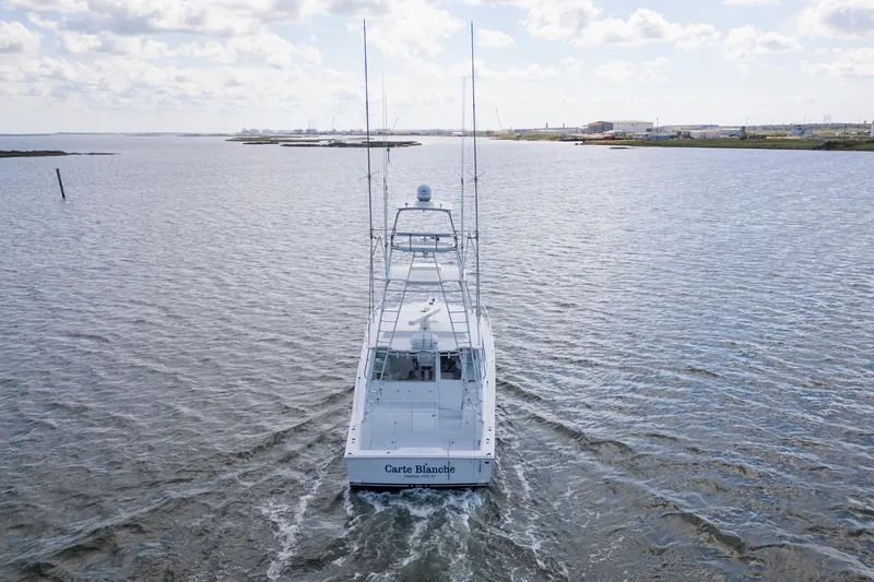  Yacht Photos Pics 2010 Cabo 45 Express yacht cruising on open water under a cloudy sky.