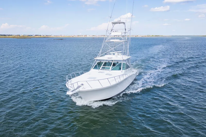  Yacht Photos Pics 2010 Cabo 45 Express yacht cruising on open water under a clear sky.