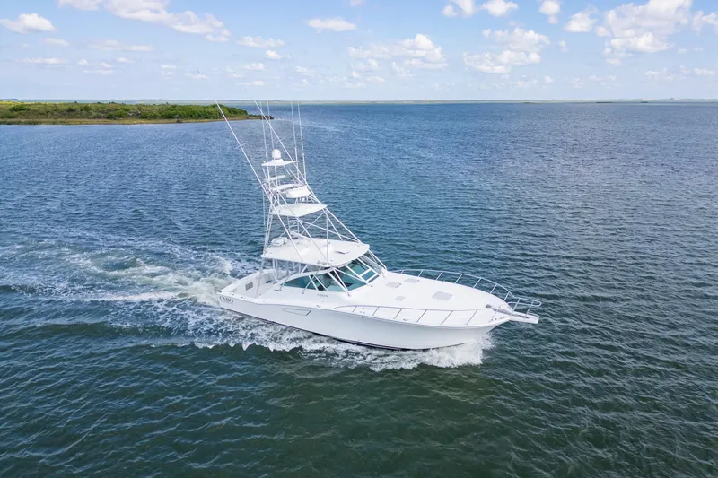  Yacht Photos Pics 2010 Cabo 45 Express yacht cruising on open water under a clear sky.