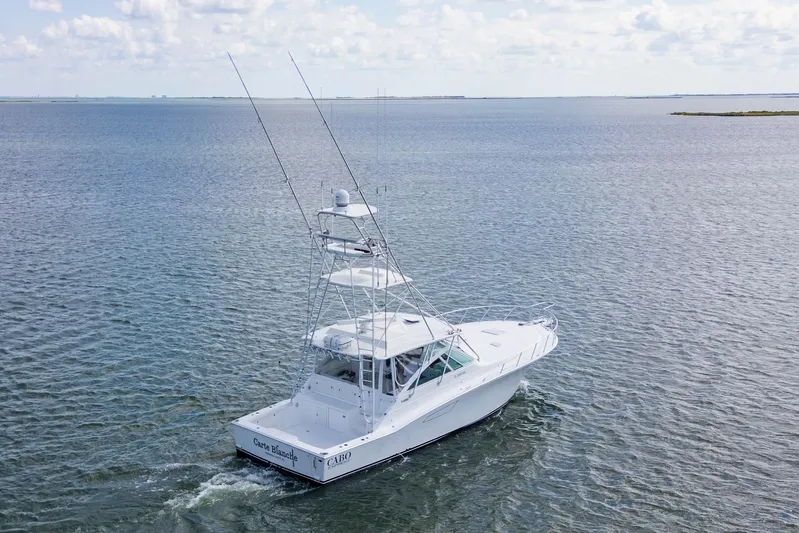  Yacht Photos Pics 2010 Cabo 45 Express boat cruising on open water under a cloudy sky.