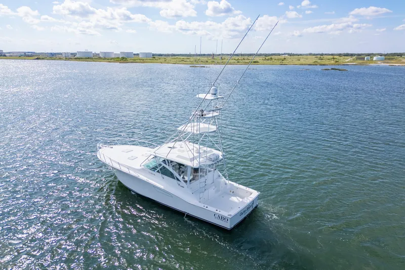  Yacht Photos Pics 2010 Cabo 45 Express boat cruising on a sunny day in open water.