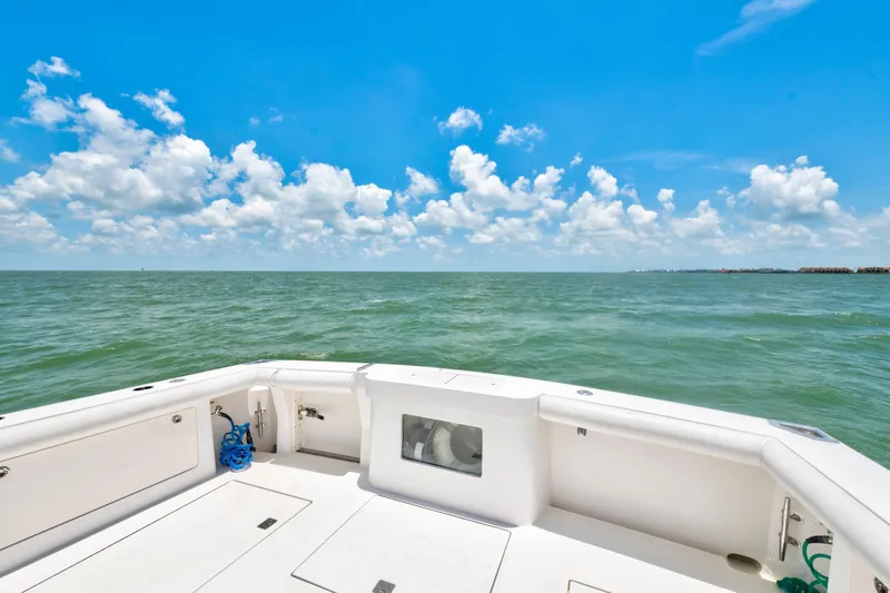  Yacht Photos Pics 2010 Cabo 45 Express boat deck overlooking calm ocean under blue sky.