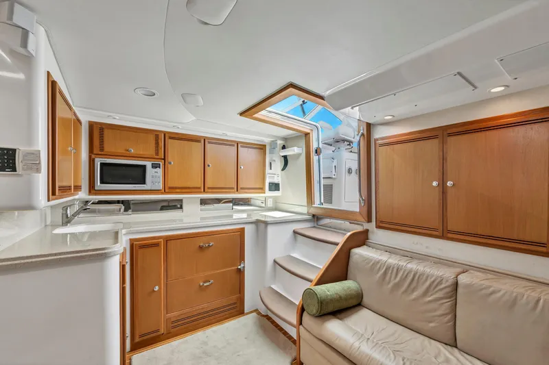  Yacht Photos Pics Luxurious 2010 Cabo 45 Express yacht interior with modern kitchen and comfortable seating.