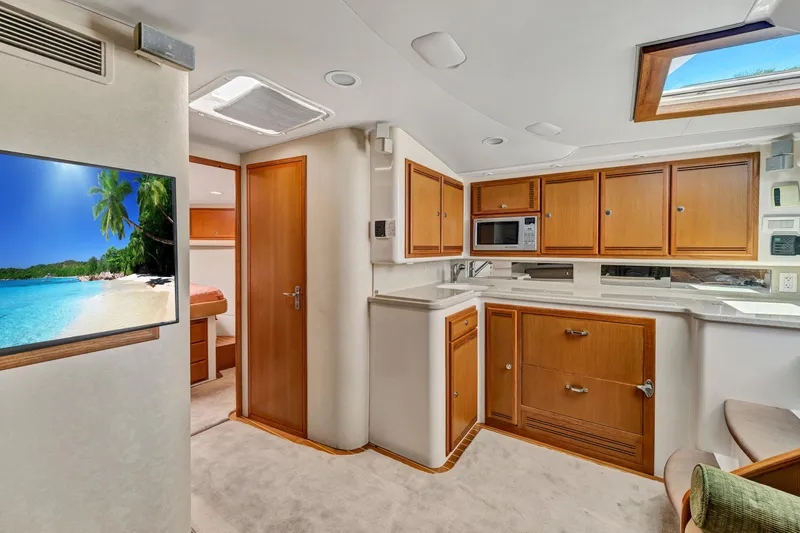  Yacht Photos Pics Luxurious 2010 Cabo 45 Express yacht interior with modern kitchen and cozy living space.