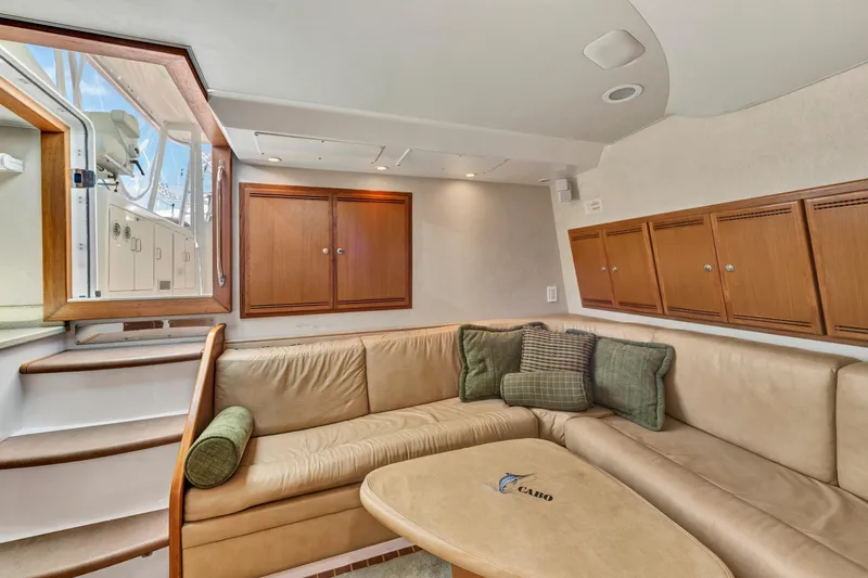  Yacht Photos Pics Luxurious interior of 2010 Cabo 45 Express yacht with beige seating and wooden cabinets.