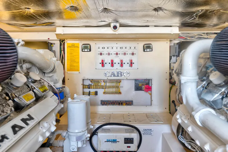  Yacht Photos Pics Engine room of 2010 Cabo 45 Express boat, featuring control panel and machinery.