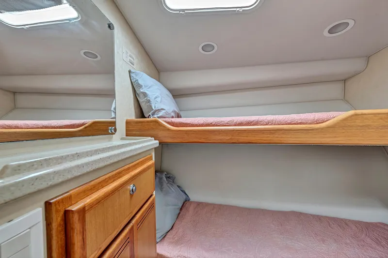  Yacht Photos Pics 2010 Cabo 45 Express cabin interior with bunk beds and wooden cabinetry.
