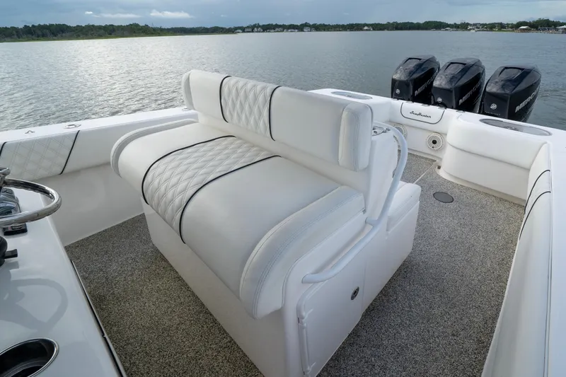 Hoo Hunter Yacht Photos Pics 2012 SeaHunter 37 Tournament boat interior with white seating and triple outboard motors.