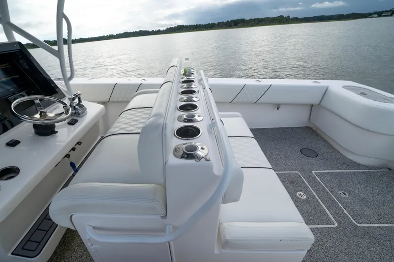 Hoo Hunter Yacht Photos Pics 2012 SeaHunter 37 Tournament boat interior with seating and control panel on a calm lake.