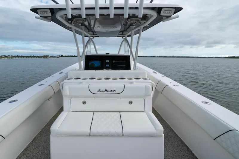 Hoo Hunter Yacht Photos Pics 2012 SeaHunter 37 Tournament boat on calm water, featuring sleek white seating and console.