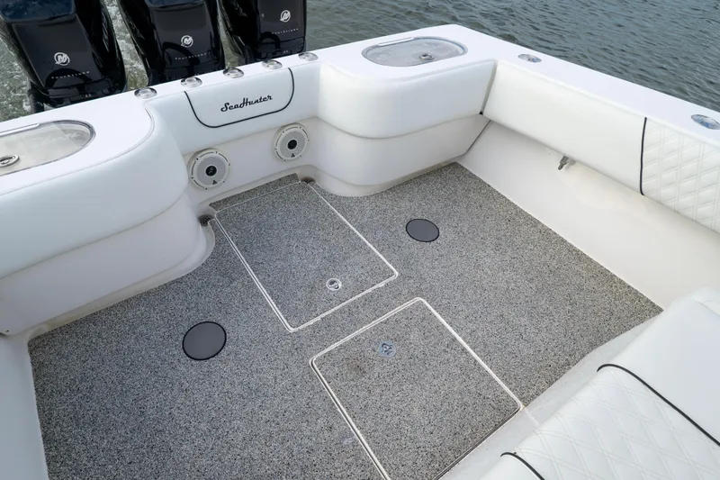 Hoo Hunter Yacht Photos Pics 2012 SeaHunter 37 Tournament boat deck with white seating and storage compartments.