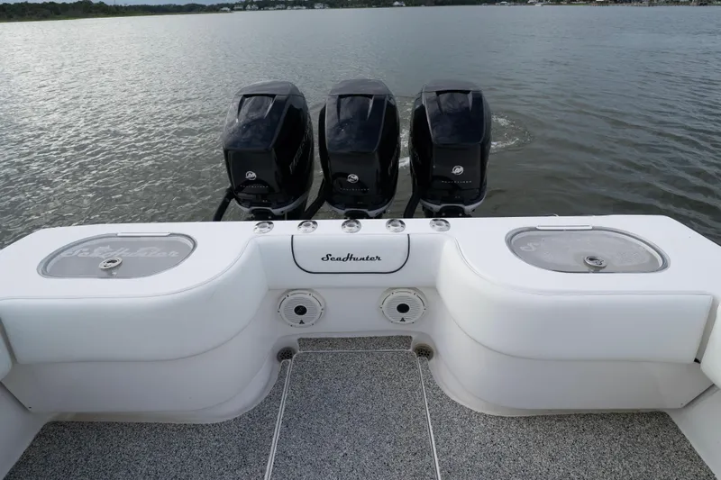 Hoo Hunter Yacht Photos Pics 2012 SeaHunter 37 Tournament boat with triple outboard engines on a calm lake.