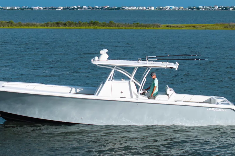 Hoo Hunter Yacht Photos Pics 2012 SeaHunter 37 Tournament boat cruising on a calm sea with scenic background.