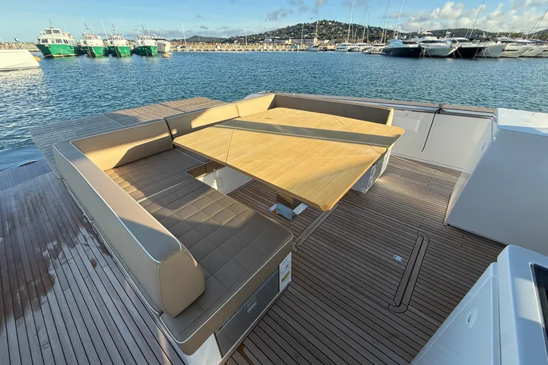 Five 3 Yacht Photos Pics Luxury seating area on 2024 Pardo Yachts 50, featuring elegant wooden deck and table.