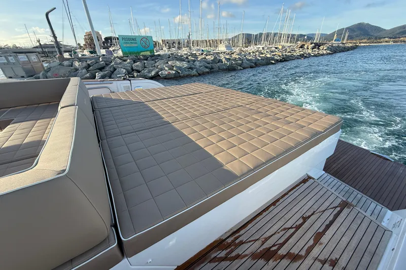 Five 3 Yacht Photos Pics Luxurious deck of 2024 Pardo Yachts 50 with cushioned seating and scenic marina view.