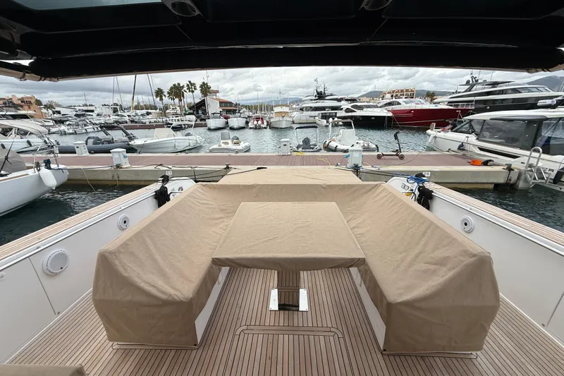 Five 3 Yacht Photos Pics 2024 Pardo Yachts 50 at marina, featuring covered seating and table on deck.