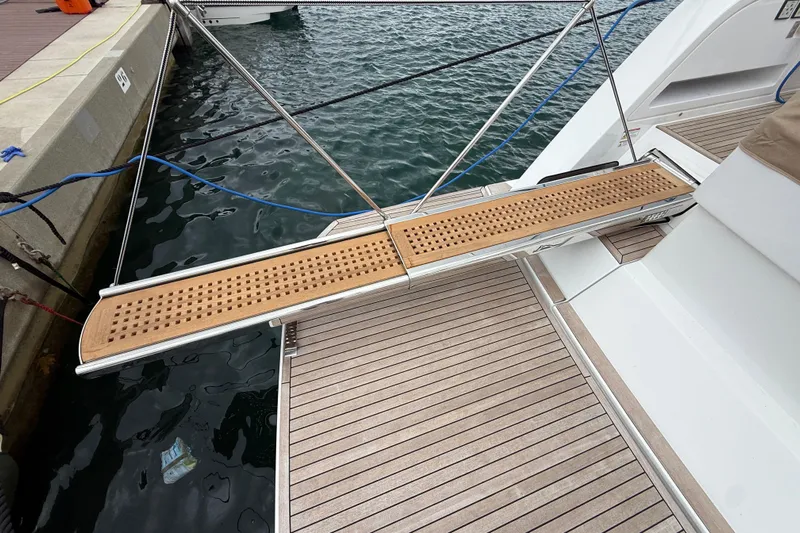 Five 3 Yacht Photos Pics Gangway of 2024 Pardo Yachts 50, docked with wooden deck and water view.