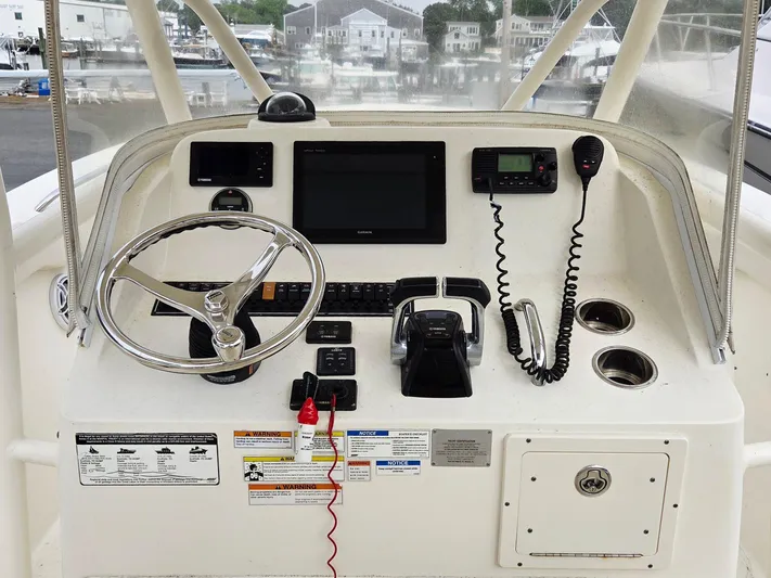  Yacht Photos Pics 2014 Pursuit C 280 Center Console helm with steering wheel, controls, and navigation equipment.