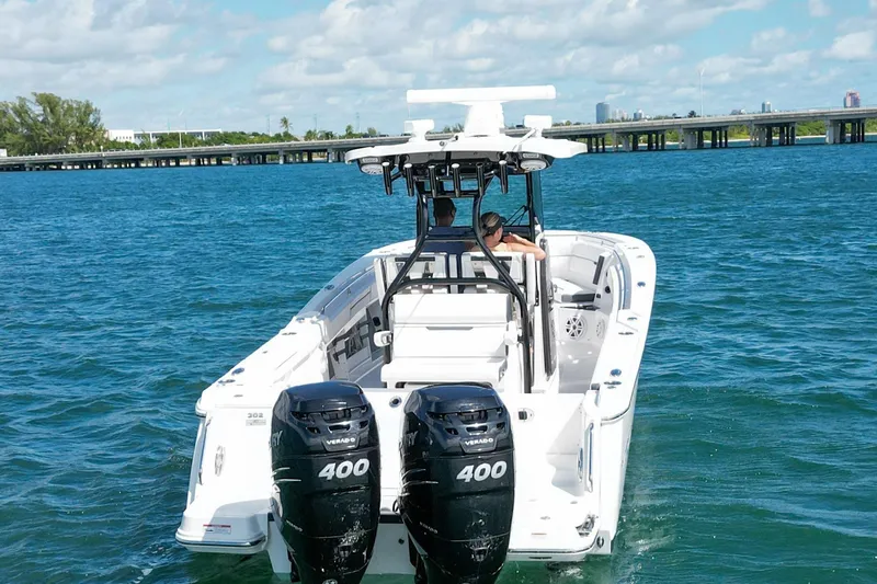  Yacht Photos Pics 2023 Blackfin 302 CC boat cruising on blue water with twin 400 engines.