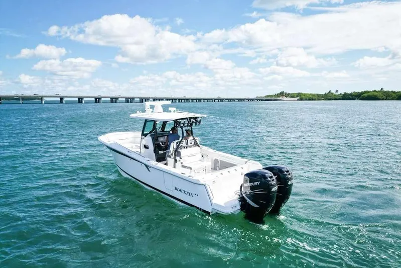  Yacht Photos Pics 2023 Blackfin 302 CC boat on open water with twin Mercury engines.