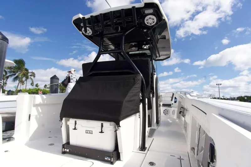  Yacht Photos Pics 2023 Blackfin 302 CC boat with Yeti cooler, under clear blue sky.