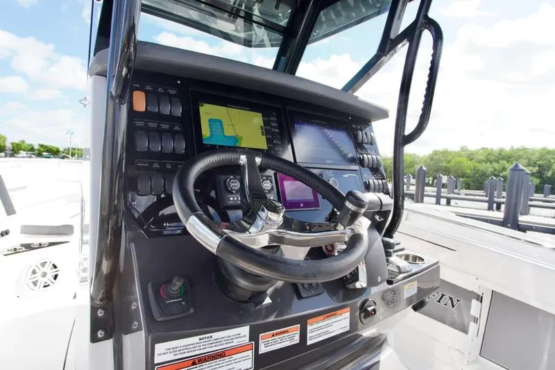  Yacht Photos Pics 2023 Blackfin 302 CC boat dashboard with steering wheel and navigation screens.