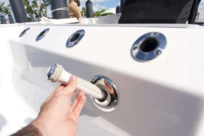  Yacht Photos Pics Hand holding a hose on a 2023 Blackfin 302 CC boat deck.