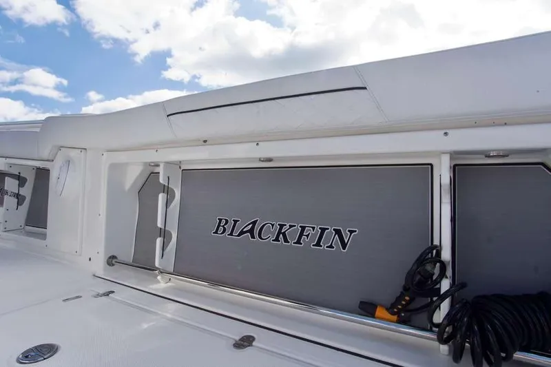  Yacht Photos Pics 2023 Blackfin 302 CC boat interior with storage compartment and coiled cable.