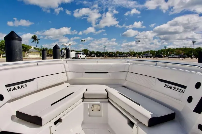  Yacht Photos Pics 2023 Blackfin 302 CC boat interior with white seating under a blue sky.