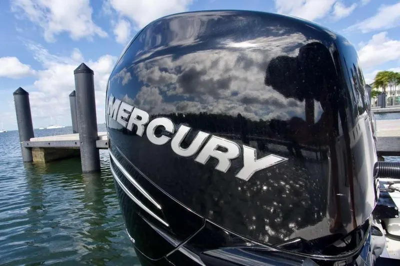  Yacht Photos Pics Mercury outboard motor on 2023 Blackfin 302 CC boat, docked by the water.