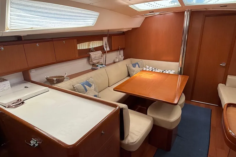  Yacht Photos Pics Interior of 2007 Beneteau Oceanis 46 yacht with cozy seating and wooden table.