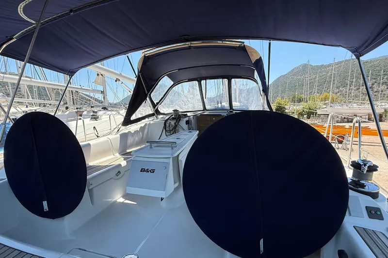  Yacht Photos Pics 2007 Beneteau Oceanis 46 yacht cockpit with blue canopy and steering wheel covers.