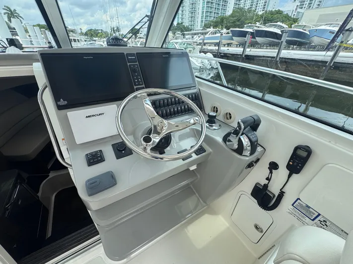  Yacht Photos Pics 2015 Boston Whaler 345 Conquest helm with modern controls and dual screens at marina.
