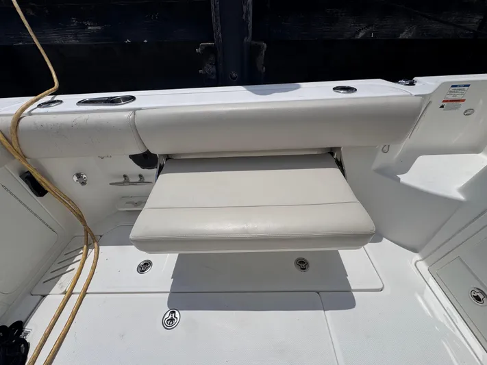  Yacht Photos Pics 2015 Boston Whaler 345 Conquest boat seat with white upholstery and deck view.