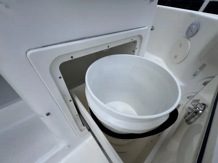  Yacht Photos Pics 2015 Boston Whaler 345 Conquest storage compartment with white bucket.