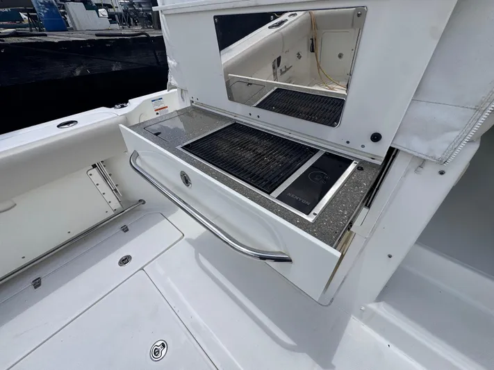  Yacht Photos Pics Outdoor grill on 2015 Boston Whaler 345 Conquest boat, featuring sleek design and stainless steel finish.