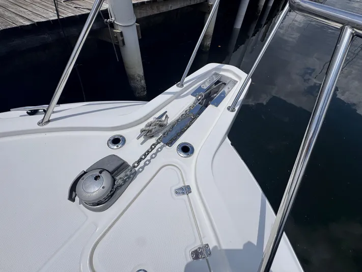  Yacht Photos Pics Bow of 2015 Boston Whaler 345 Conquest with anchor and railing, docked at marina.